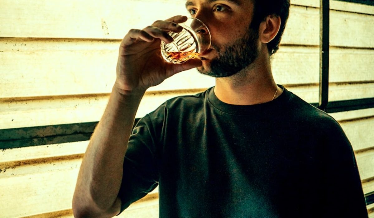a man drinking from a glass